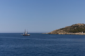 Fototapeta premium Traditional wooden sailboat cruising in open Mediterranean sea near coast, Malta, June 19, 2026.