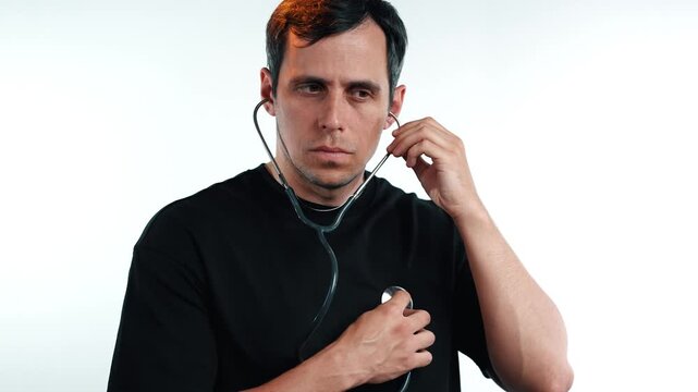 Man listening to his own heart rate using a medical stethoscope