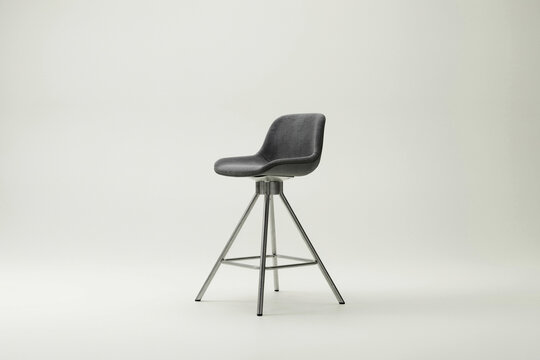 Black fabric stool with swivel base on light background, swivel stool minimalist chair des