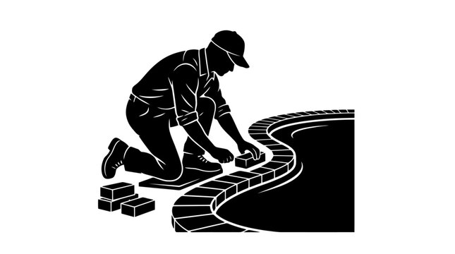 Man laying bricks on a pathway.