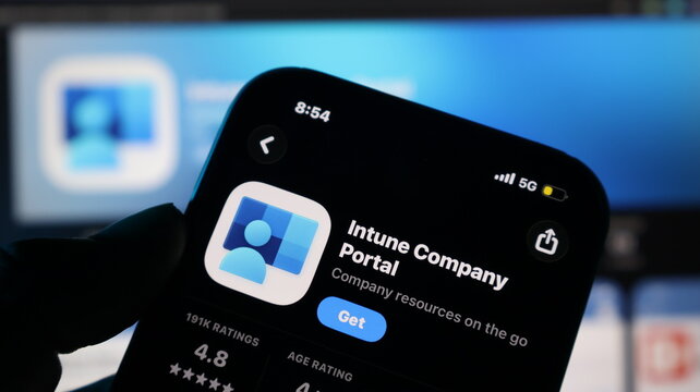 Hand holding smartphone with app store screen
