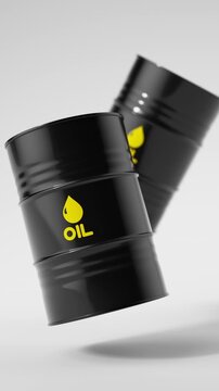 Two black metal oil barrels floating on a white background for petroleum industry concept. Vertical video.