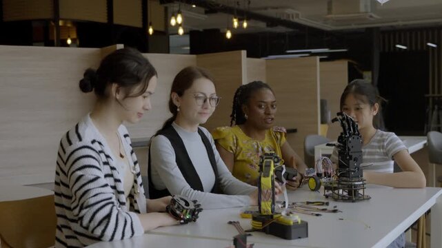 Women work on robotics project at modern workspace in afternoon hours