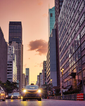 Taxi Driving on New York City Avenue at Golden Sunrise