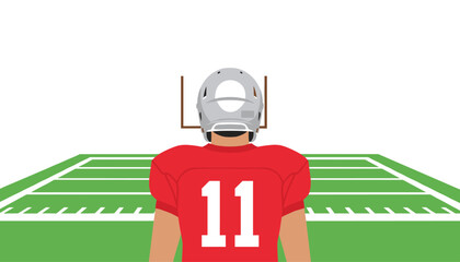 Fototapeta premium Football player wearing a red jersey with the number eleven on the back and a silver helmet standing on a field facing the goal posts.