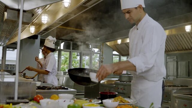 Cooking in a busy kitchen with chefs preparing meals during lunch service