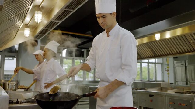 Chef cooks in a busy kitchen with team preparing meals during daytime