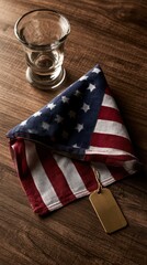 Obraz premium American flag napkin with tag and glass on wooden table, rustic dining setting