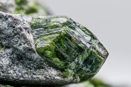 Natural mineral specimen featuring vivid green epidote crystals embedded in rock texture