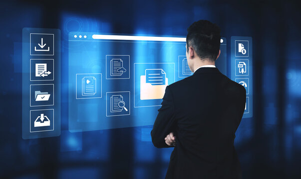 Businessman Analyzing Digital Data with Interactive Touchscreen Interface in Futuristic Office Setting for Technology Concept. Glyphic.