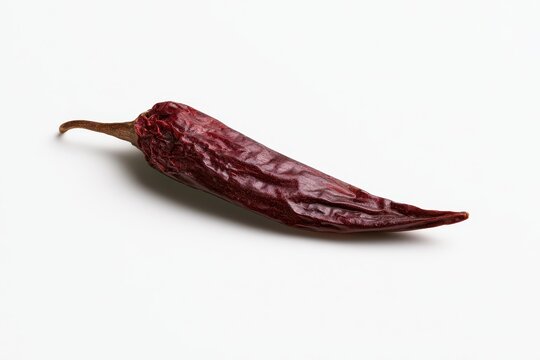 Red-brown dried guajillo chili pepper with minimal white background and negative space