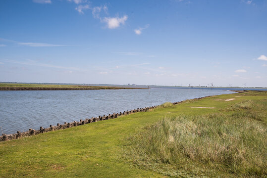 Scenic coastal dyke and water channel in Nordstrand near Husum Schleswig Holstein