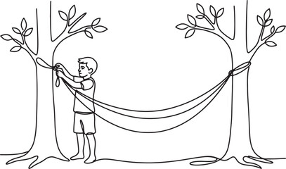 boy setting up hammock between two trees in forest