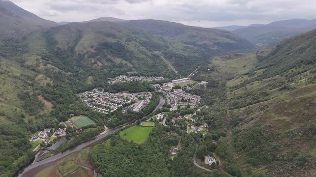 Aerial drone push forward shot of Loch Leven at the village Kinlochleven, part of the West Highland Way in Scotland.