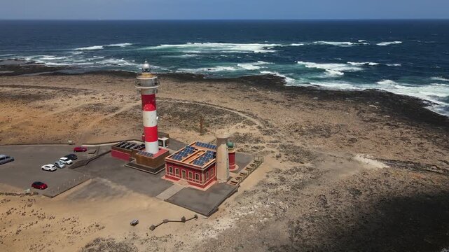 Beautiful aerial footage showing the iconic Toston lighthouse, also known as El Cotillo, on the rugged volcanic coastline of Fuerteventura