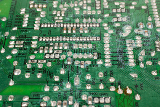 Close-up of electronic pathways and soldering points. Detailed information on printed circuit board technology. Copper traces on the substrate,