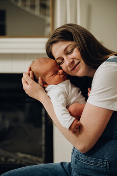 Mother hugs her sleeping newborn baby