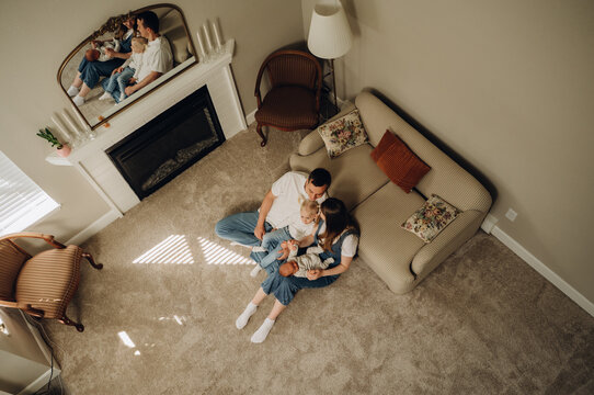 Top view of a happy family with two children in a cozy living room.