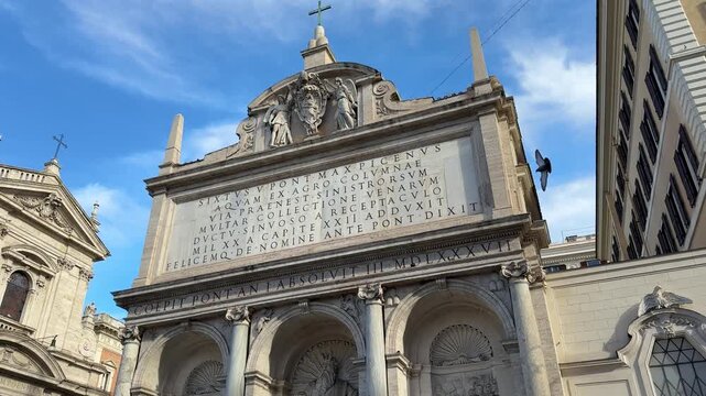 Rome, Italy Historic Catholic church facade with Latin inscription and stone arches in Rome Italy under blue sky close up famous European architecture travel video