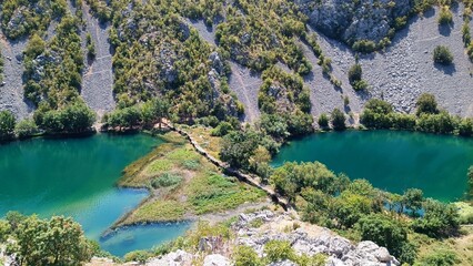 Kudin Most stone bridge on Krupa river canyon, Croatia. Beautiful turquoise river and green nature landscape from above