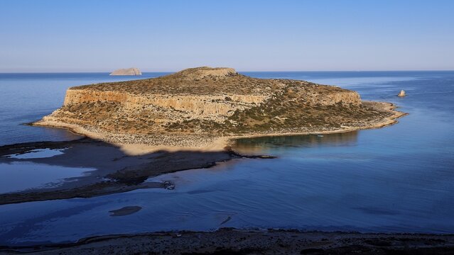 Island surrounded by calm sea with rocky cliffs, under clear day skies, natural beauty, Gramvoussa, Gramvoussa Peninsula, Pirate Bay, Balos, lagoon, north-west Crete, Crete, Greek Islands, Greece