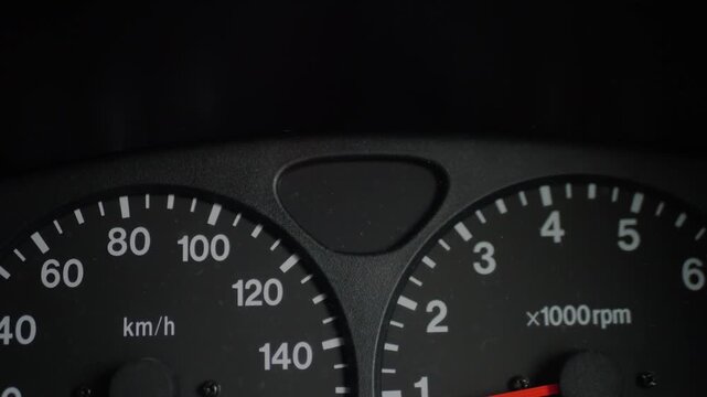 Close-up of car dashboard displaying illuminated green turn signal indicators in a dark cabin, representing vehicle safety, navigation, and driver alerts.