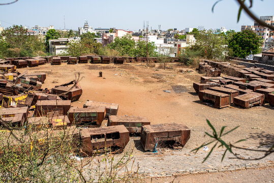 Large storage yard of rusty metal dumpsters in Bhavnagar.