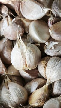Many fresh garlic bulbs forming an interesting texture at supermarket