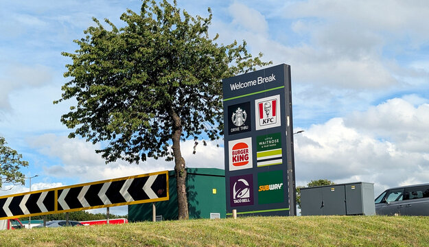 Leicester, England, UK - 18 June 2026: Welcome Break motorway service station totem sign with franchise logos, roadside fast food and retail billboard display in the UK