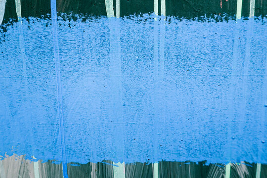 Old wall background with blue painted line over stripped green and white wall background
