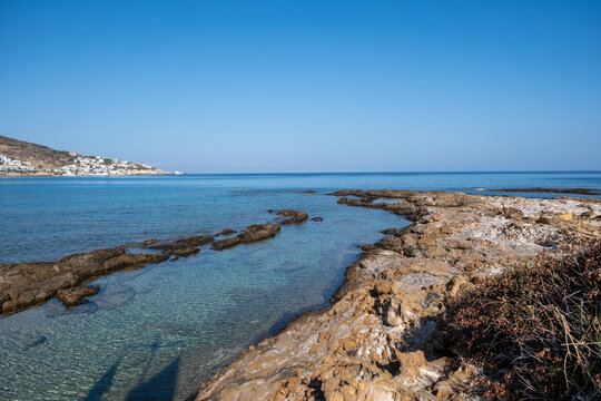 Armenistis village and bay in Ikaria island, Greece. Hillside houses, blue Aegean sea water, sunny summer day.