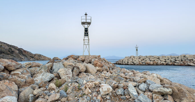 Lighthouses on rocky breakwaters at Agios Kirikos harbor, Ikaria island, Greece