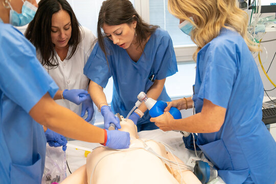 Medical team practicing advanced life support on mannequin