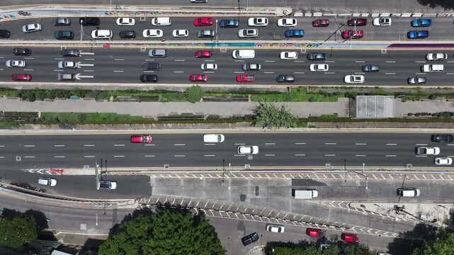 Title: Aerial top-down view of the drone descending over the Ecoducto and Viaducto in Mexico City with heavy traffic flowing along the multi-lane avenue