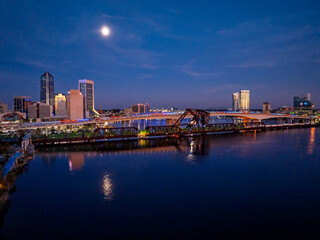 Obraz premium Drone View of the Acosta Bridge, Main Street Bridge and Downtown Jacksonville at Blue Hour