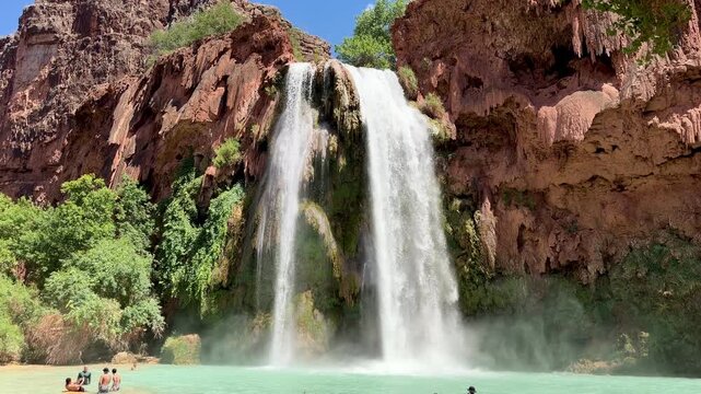 Visitors Swimming at Havasu Falls Waterfall in Havasupai Canyon