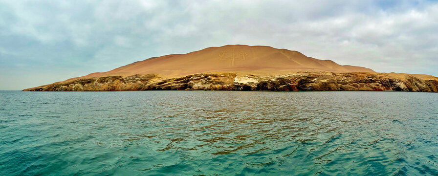Peru, South America: panoramic view of El Candelabro (The Candelabra, also known as the Trident), impressive and mysterious pre-Inca geoglyph on a sandy hillside in the Paracas National Reserve
