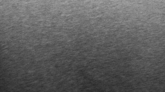 dark gray heather cotton fabric texture creates a minimalist abstract background for sustainable fashion design