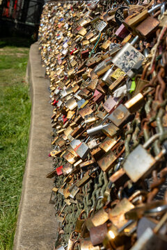 Thousands of love locks cadenas d'amour covering metal surfaces on Montmartre's bridge, symbolizing eternal commitment, marriage vows, and romantic devotion, Parisian tradition