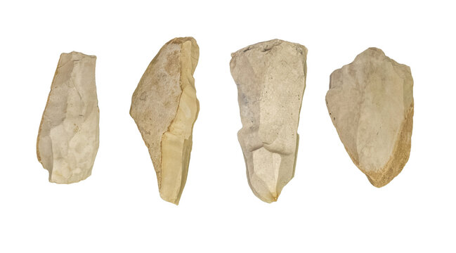 Set of prehistoric flint stone tools isolated on white background, four ancient chipped rock artifacts and hand axe blades, archaeology museum, Stone Age technology and history concept, no people