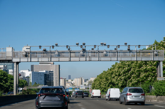 View of a French and European autoroute with overhead speed cameras, showing lanes, traffic and motorway infrastructure, road signes