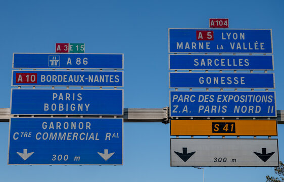 View of a French and European autoroute with overhead directional signs pointing to major cities like Paris, Bordeaux, Lille, Calais, showing lanes, traffic and motorway infrastructure, road signes