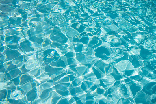 Summer vacation at ocean shore. Blue ocean rippled water texture reflection. Ripple water in summer pool. Sea surface background. Vacation resort water background. Sea beach