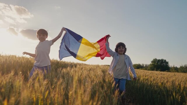 Little children boys runs with Romanian flag as it flutters in wind. Romanias deep agricultural heritage, patriotic spirit, land, new generation. Farming, Eastern European
