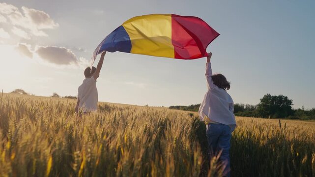 Little children boys runs with Romanian flag as it flutters in wind. Romanias deep agricultural heritage, patriotic spirit, land, new generation. Farming, Eastern European