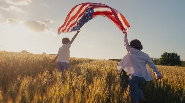 Cute little boys - American patriot kids running with national flag on open area countryside road.USA, 4th of July - Independence day, celebration. US banner,memorial Veterans,election.
