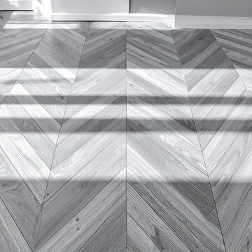 Chevron Pattern Wooden Floor with Sunlight Shadows in Interior
