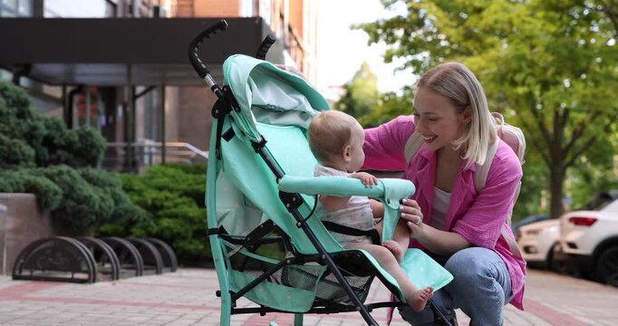 Baby carriage. Mother and her child in stroller outdoors