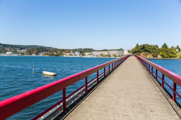 Fototapeta premium Beautiful autumn landscape with red bridge