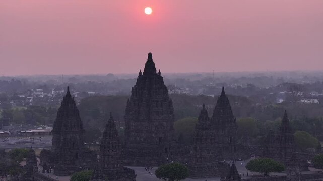 Aerial cinematic drone footage of Prambanan Temple at sunset, capturing the dramatic silhouette of ancient architecture and the beauty of Indonesia&rsquo;s cultural heritage.